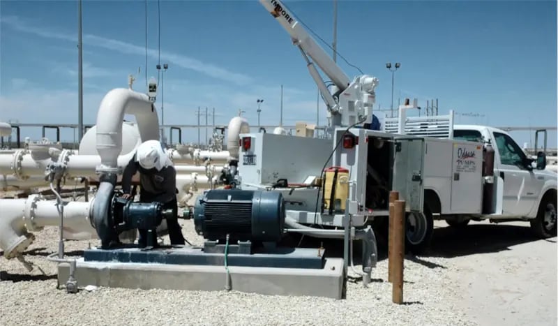Photo showing Odessa Pumps, a DistributionNOW company, pump technician performing field service on a pump with our field service truck. Photo showing Odessa Pumps, a DistributionNOW company, pump technician performing field service on a pump with our field service truck.