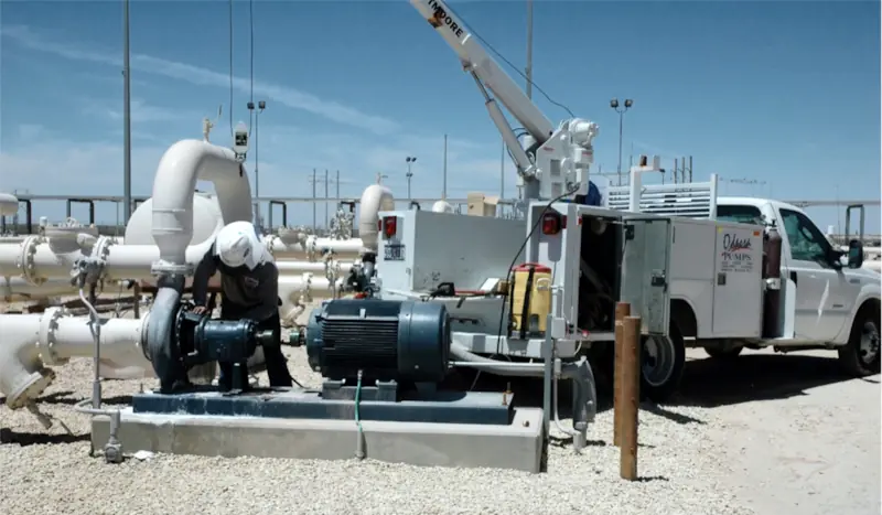 Photo showing Odessa Pumps, a DistributionNOW company, pump technician performing field service on a pump with our field service truck. Photo showing Odessa Pumps, a DistributionNOW company, pump technician performing field service on a pump with our field service truck.